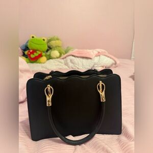 Chic Black Handbag with Gold Accents and cheetah print interior